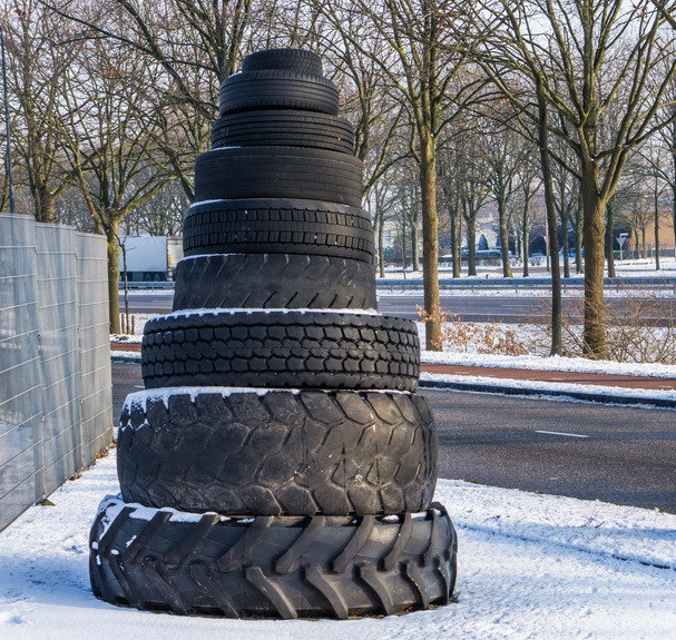 tower of stacked tires in all kinds of sizes and shapes