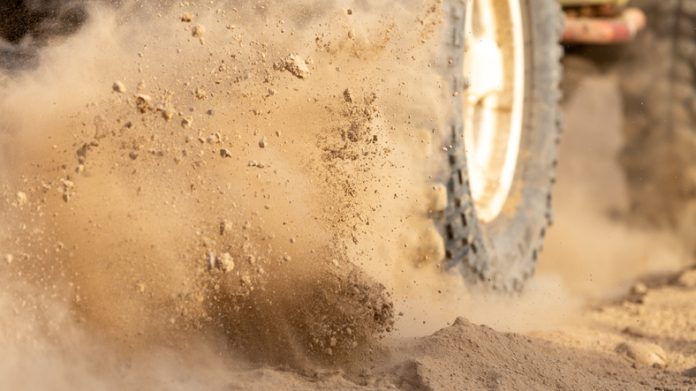Offroad vehicle bashing through sand in the desert.