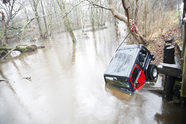 Car Being Lifted and Rescued from Flooded River