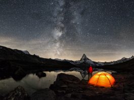 An illuminated tent under Milky Way at Matterhorn in Switzerland