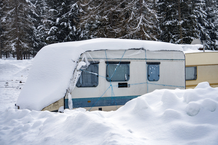 rv trailer covered by white snow