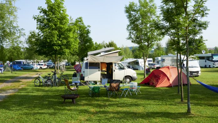 Camper van at a full campsite