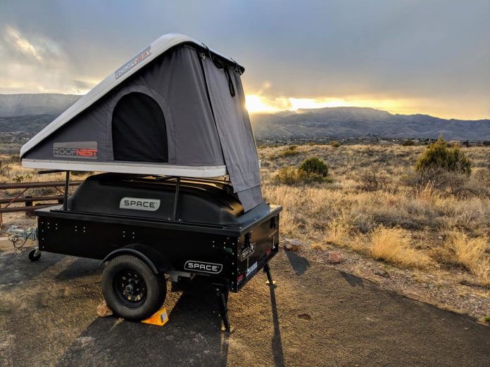 space trailer with rooftop tent at sunset