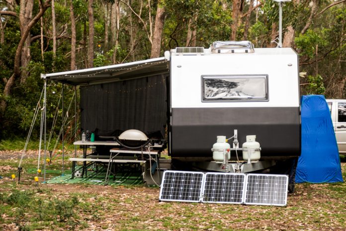 camper with solar panels in the forest