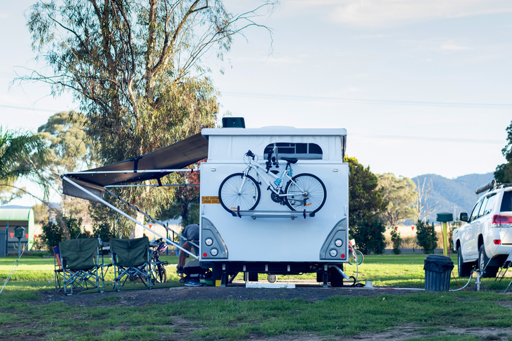 RV caravan camping on a campsite at the caravan park. Camping vacation travel concept
