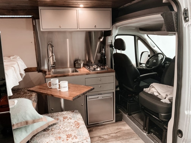 Cozy space in a Ram ProMaster van by Camplife Customs