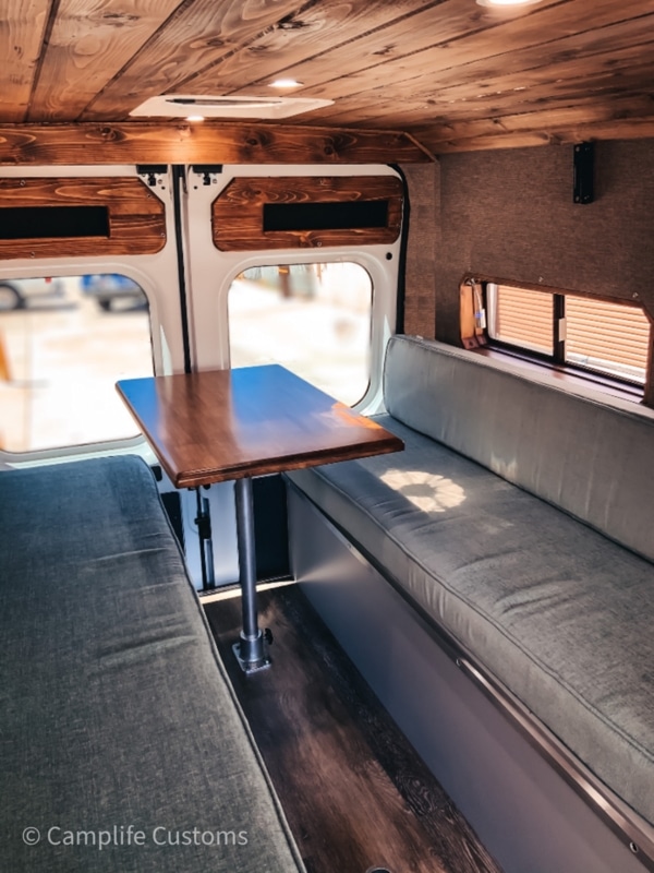 Table inside a Ram ProMaster van by Camplife Customs