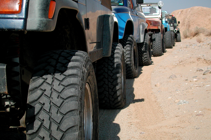 Five jeeps in a row on offroad trail. 