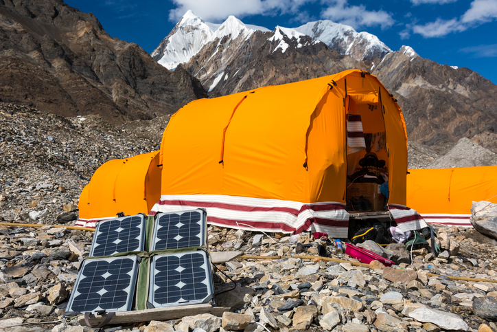 Solar Panels next to a tent on a mountain