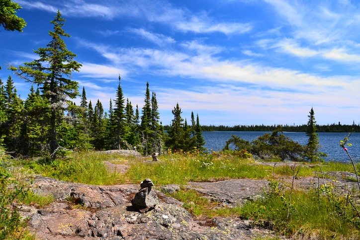 Isle Royale National Park hiking trail over rocky terrain with cairns to mark the route.