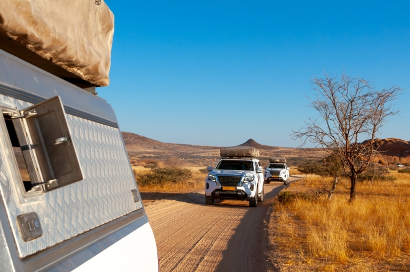 Two SUV 4x4 cars with rooftop tents driving in convoy 